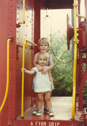David with sister Susan standing in the red caboose